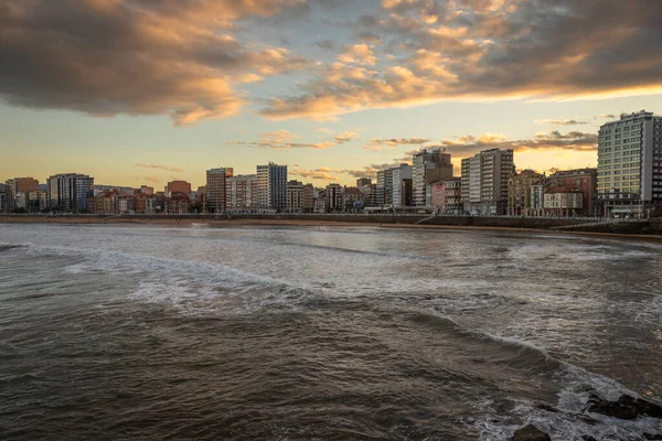 stock image Exposure from the Gijon boardwalk of the beautiful seafront with great waves for surfing at Sunset, Spain.
