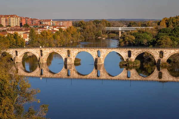 Puente de Piedra adındaki Zamora Roma köprüsünün güzel panoramik manzarası, günbatımından hemen önce, sonbahar mevsiminde, İspanya 'daki Douro Nehri' nde,.