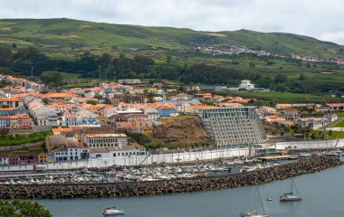 Angra do Heroismo 'nun panoramik görüntüsü Terceira Adası, Azores, Portekiz. Kırmızı çatılar, marina ve yeşil tepeler Monte Brasil 'den Atlantik Okyanusu manzaralı..
