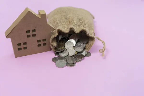 Business loans for real estate concept, A money bags with small house.