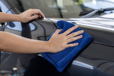 A woman is cleaning her car