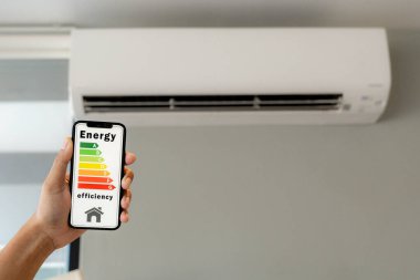 Hand holding smartphone with air conditioner, Green technology concept