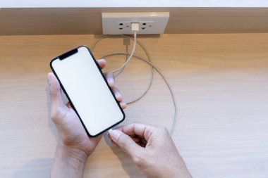 Smart phone charging,plugged into electrical outlet