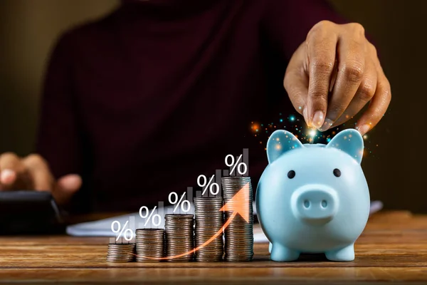 Investor saving money in piggy bank set future goals and success chart and upward arrow Save money to buy funds and investment profits, dividends, savings, interest savings.