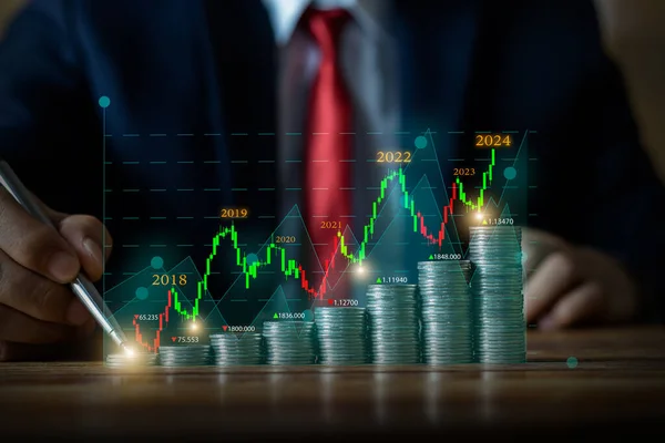 Businessman putting money coins with up arrow and yearly growth symbol for finance bank increase interest rate or mortgage investment from business growth concept.	