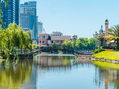Turistler ve yerliler için favori bir yer, güneşli bir gün, salkım söğüdü ve palmiye ağaçları