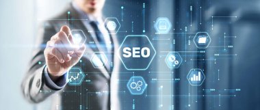 Businessmans fingers pressing a button SEO. Search engine optimization.