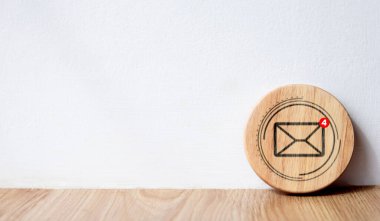 New email notification ideas for business email communication and digital marketing. Inbox that receives electronic message notifications Envelope icon on circular wooden block and white background. clipart