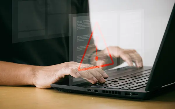 Businessman using laptop computer with triangle warning sign for error alert and maintenance concept Hack Alert Alert Computer System hacker protection