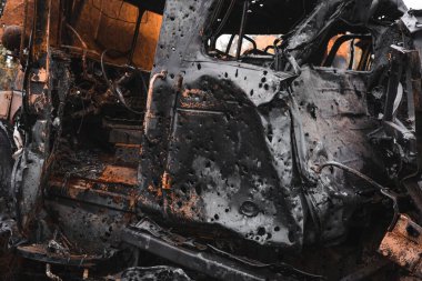War in Ukraine, a cemetery of destroyed equipment, a cabin pierced by shrapnel, a burnt KAMAZ, the city of Izyum, Kharkiv region
