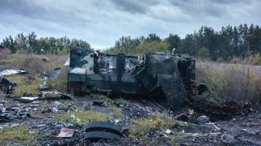 War in Ukraine, destroyed Russian armored car, military equipment, rear view, Kharkiv region.