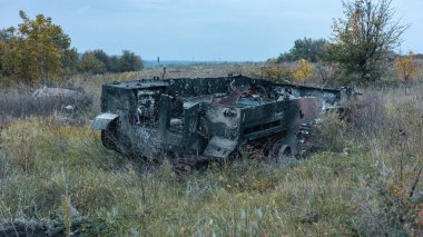 War in Ukraine, destroyed Russian armored car, military equipment, side view, Kharkiv region.