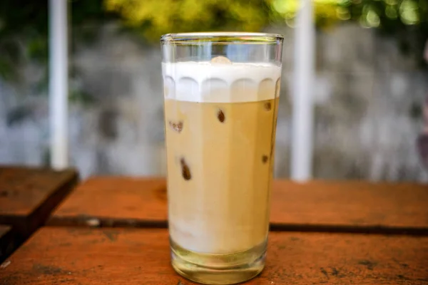 a glass of chilled capucino drink with extra ice cubes