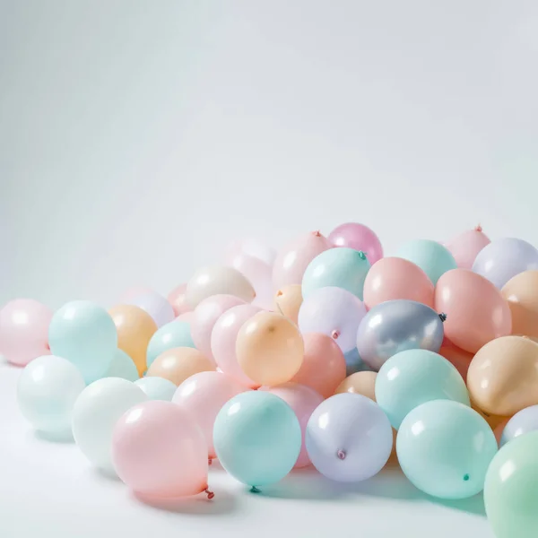 Pastel colorful balloons in white room background. Party and celebration.