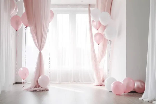 Pink and white balloon on white  room with curtain background