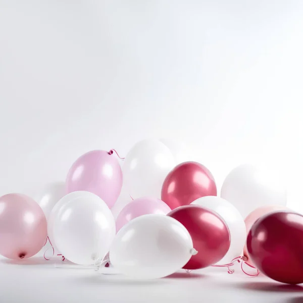 Pink gold and white balloon on white background with copy space.