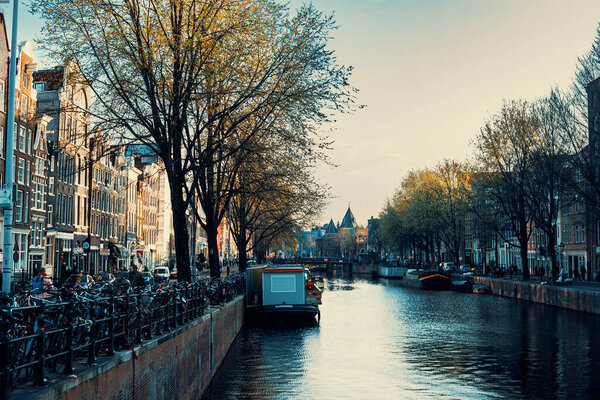 April 8th, 2023: Canals and streets with vibrant lifestyle in Amsterdam, Netherlands. Toned image.