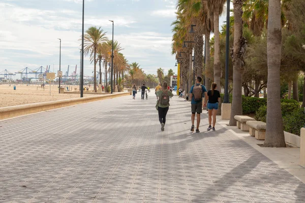 stock image Valencia, Spain : 2022 November 14 : People walking along the Paseo de Playa de las Arenas in the city of Valencia in 2022.