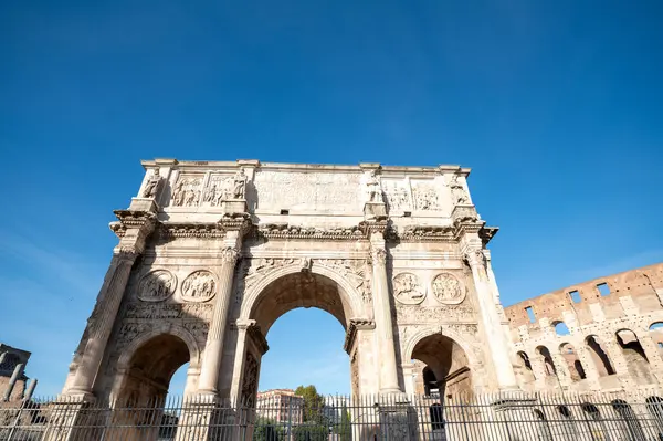 Arch of Constantine. Triumphal arch and Colosseum in the background in Rome, Italy.