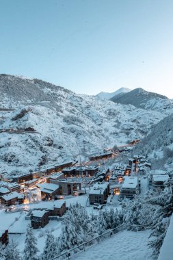 Cityscape of the tourist town of Canillo in Andorra after a heavy snowfall in winter. clipart