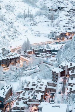 Cityscape of the tourist town of Canillo in Andorra after a heavy snowfall in winter. clipart