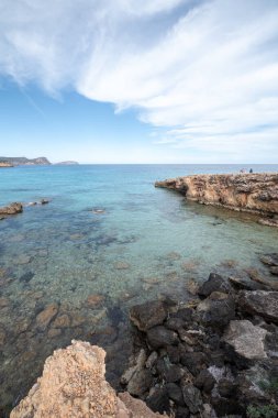 Panorama on the tourist beach of Cala Nova on the island of Ibiza in summer 2024. clipart