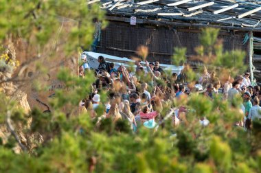Benirras, İbiza, İspanya: 15 Mayıs 2024: 2024 'te İbiza' daki Benirras plajında bir Pazar klasiği olan davul seansındaki insanlar.