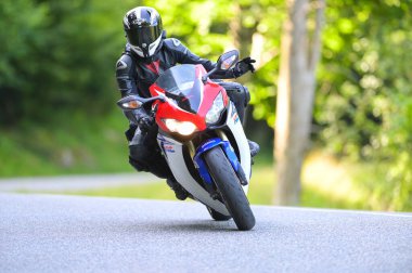 Col du Portillon, France : 2024 July 20 : Biker on his Honda HRC on the road on the Col du Portillon in France on July 20, 2024. on the road on the Col du Portillon in France on July 20, 2024. clipart