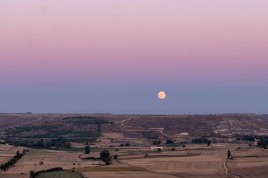 Moonrise from the medieval castle of Castrojeriz built in the municipality of Castrojeriz in the 13th century, in Burgos in October 2024. clipart