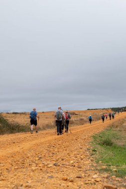 Pilgrims on the rbigo Paso Honroso Bridge in Hospital de rbigo on the Camino de Santiago in 2024. clipart