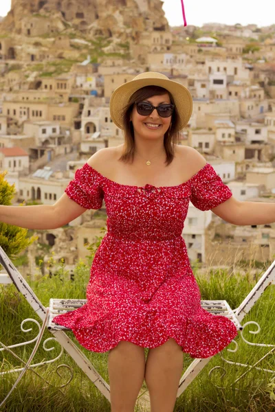 stock image happy woman in a hat on the terrace in cappadocia, turkey