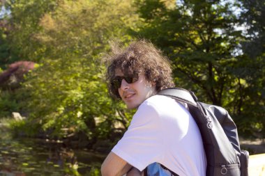 Polonya 'daki parkta güneş gözlüklü bir gencin portresi.