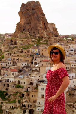 Kapadokya manzarasına bakan beyaz şapkalı güzel kadın, hindi.