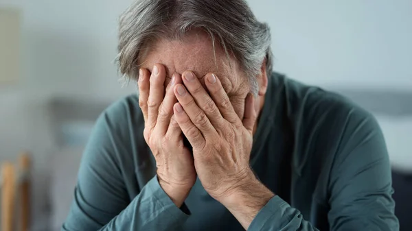 stock image Portrait of old man covering his face with his hands