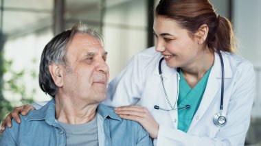 Doctor comforting patient by touching shoulder