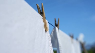 Clothes hanging to dry on a laundry line clipart