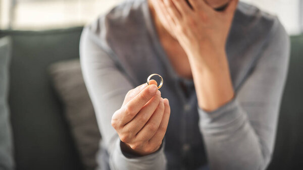 Woman takes off an wedding ring