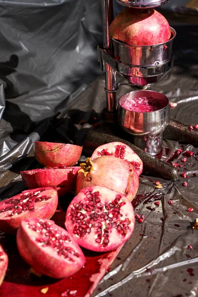 Juicy ripe pomegranate fruits on the market counter for juice. Pomegranate harvest on agricultural farm, vitamins, fruits, tropics concept. High quality photo