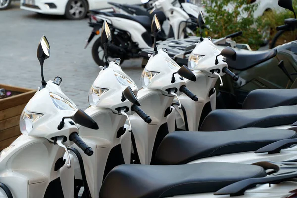 stock image Motorcycles for rent or for sale on the city street. Lots of white scooters to ride. High quality photo