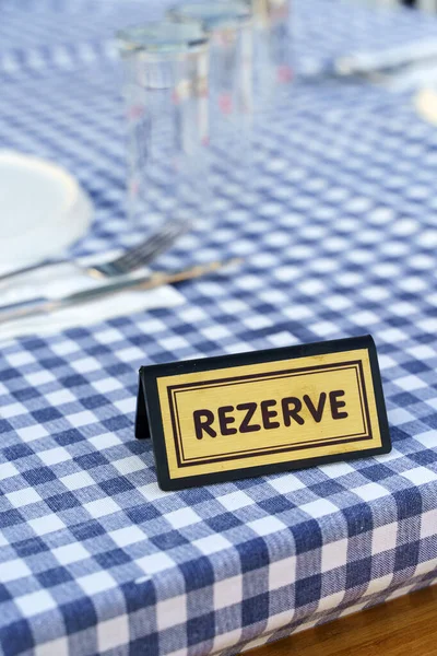 Reserve table dinner. A plate for reserving a table in a restaurant for an evening dinner. High quality photo