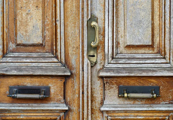 Old vintage door. Antique wooden door background with lock and handle on architecture facade home. . High quality photo
