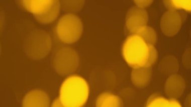 Altın bulanık Bokeh soyut arkaplanı. Sarı ışık yüzeyi ışıl ışıl parlıyor. Tatil, kutlama performansı konsepti. Yüksek kaliteli FullHD görüntüler