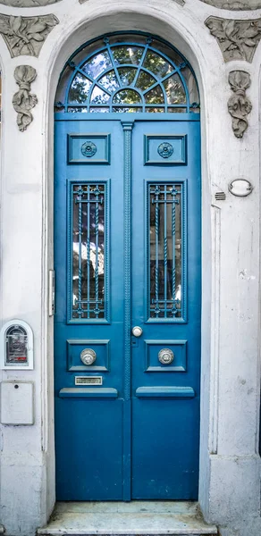 Old vintage door. Antique blu door background with lock and handle on architecture facade home. High quality photo