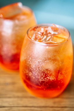 Cold cocktail. Summer soft drink with ice based on orange juice and syrup in a glass. High quality photo