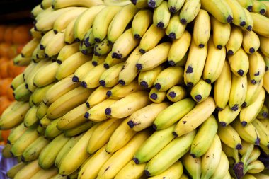 Bananas on the market. Harvest of yellow ripe bananas is sold at the farmers eco market. High quality photo