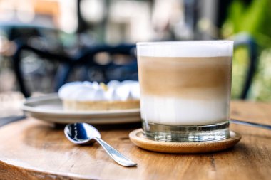 Coffee and cake on a cafe table outside. Morning, drink, good mood concept. High quality photo