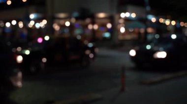 Night city street with lights and cars. Blurred night city life background. Bokeh defocus texture. High quality FullHD footage