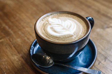 Kafedeki bir masada bir fincan cappuccino kahvesi. Sabahları kahvaltıda seramik bardakta sıcak kahve içerim. Yüksek kalite fotoğraf