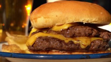 Cheeseburger with beef meat on a plate in a fast food restaurant of American cuisine. Food, taste, meat concept. High quality FullHD footage