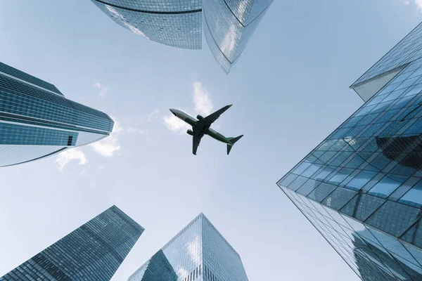 stock image Airplane flying on business skyscrapers of financial center. Travel, economy, cargo, transportation concept. High quality photo